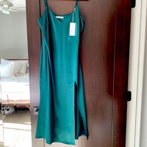 Reformation 100% silk Emerald green dress with a slit up the side. NWT